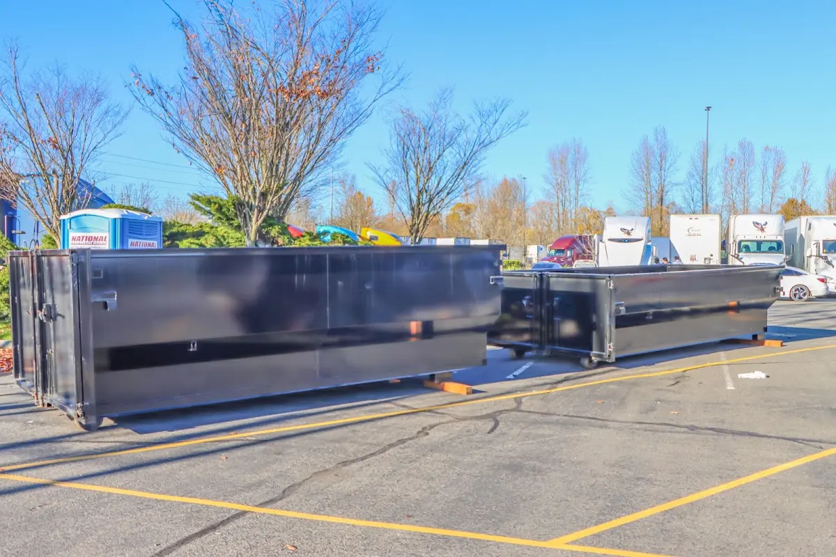 Professional dumpster rental service with roll-off container on residential driveway in Winthrop